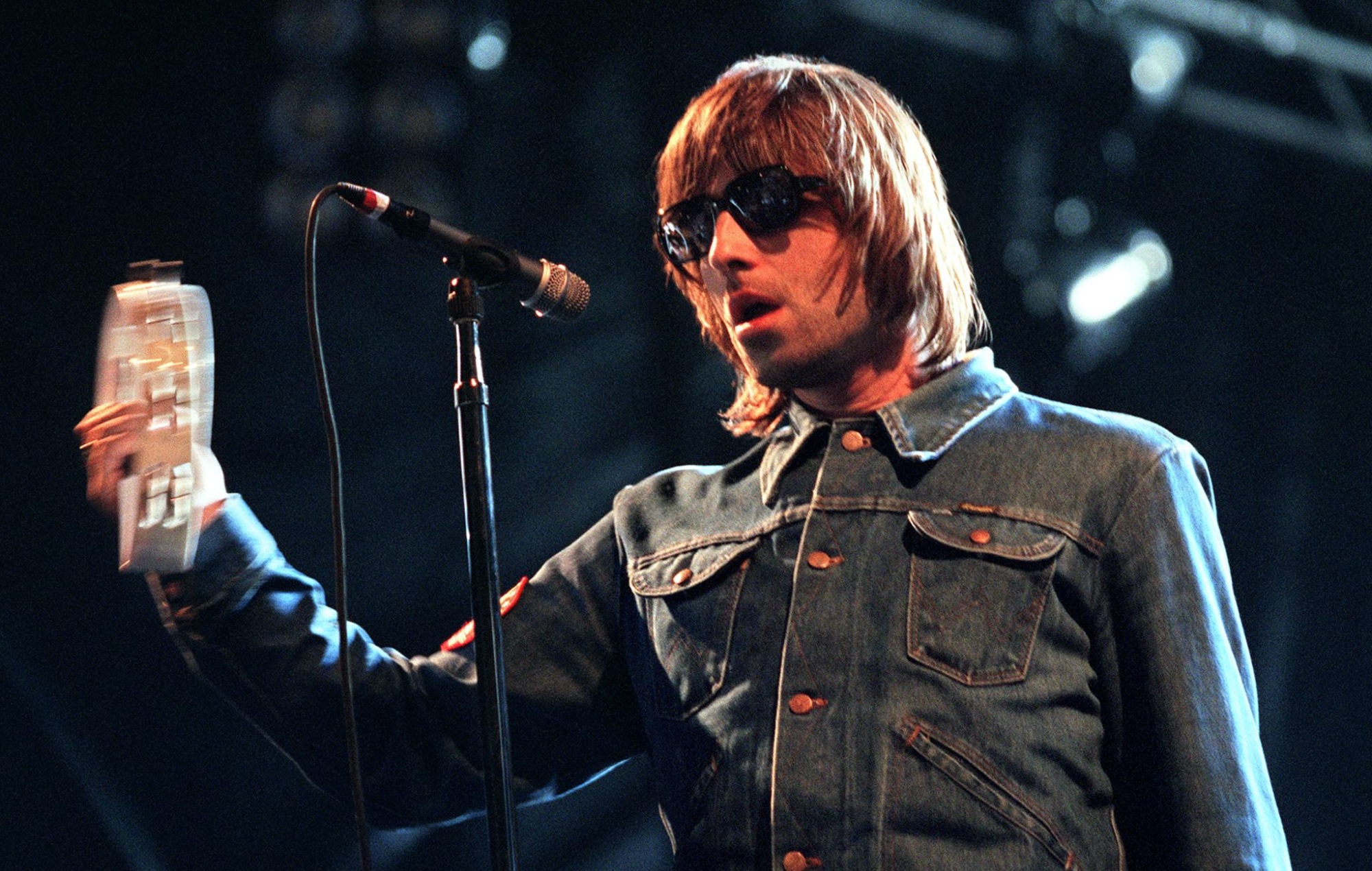 Liam Gallagher se produisant en direct sur scène avec Oasis en 2000